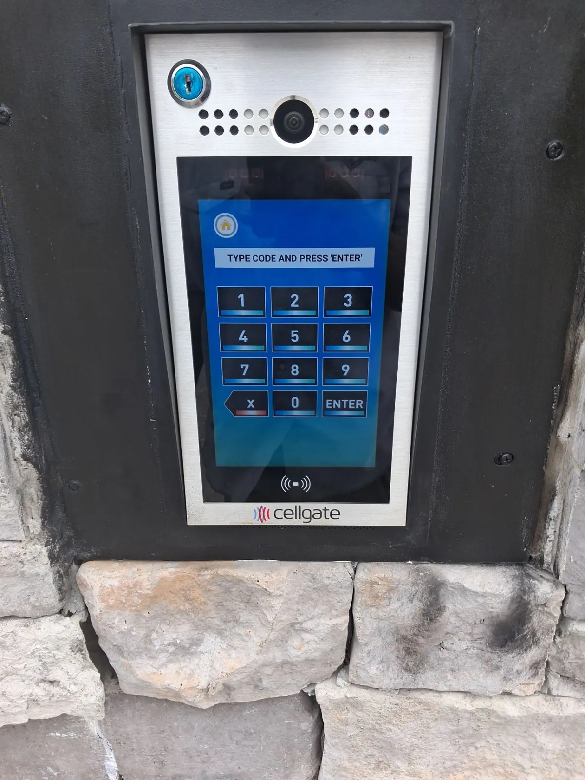 Touchscreen keypad entry panel set into a stone column in Clermont, FL